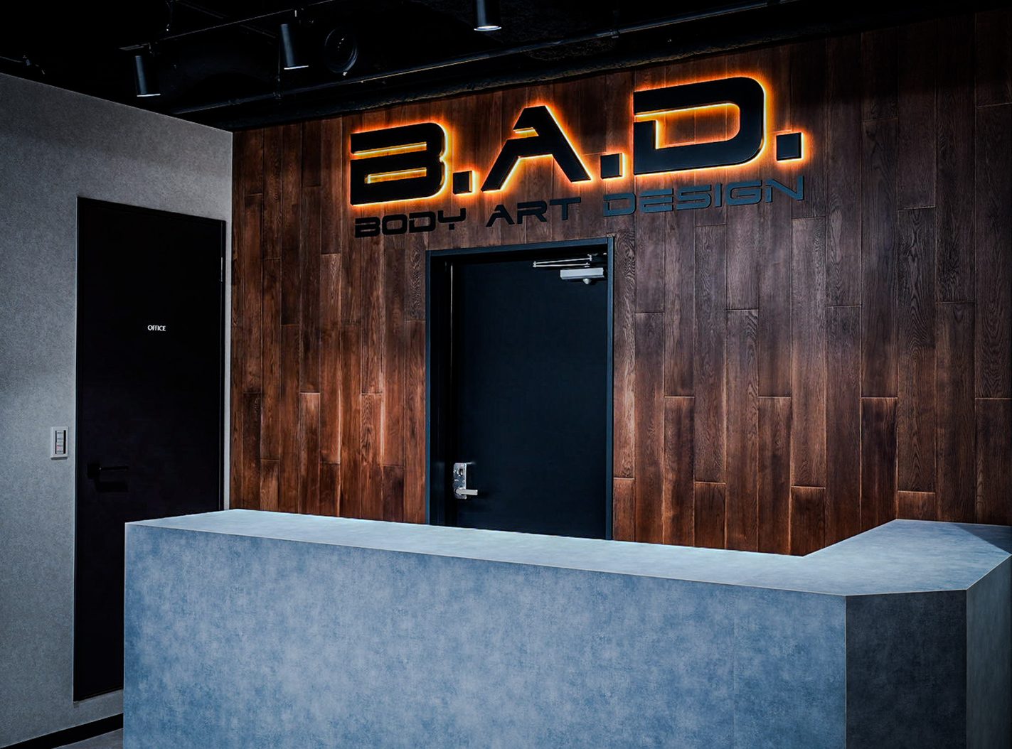 The backlit B.A.D. sign and the reception counter